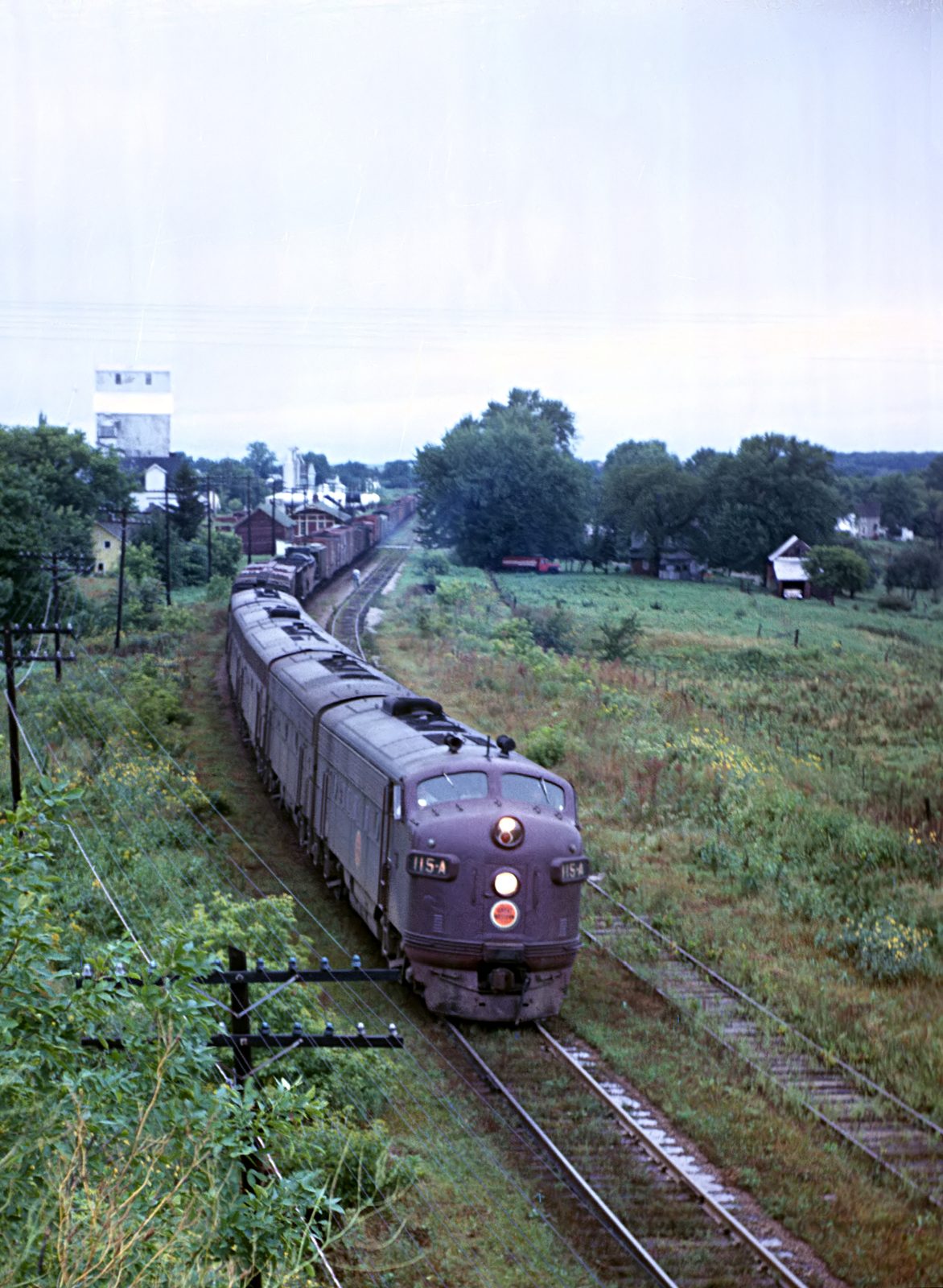 A Chicago Great Western freight passing the Kenyon elevators in 1962
