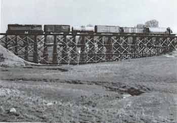 A freight train crossing the timber trestle at Kenyon